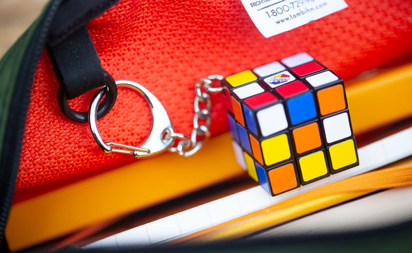 Close up detail of an o-ring inside a Texturized Orange Grab Bag with a mini Rubik's Cube attached.